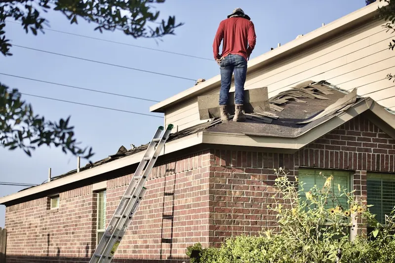 Professional roofer working on a residential roof in Counsman